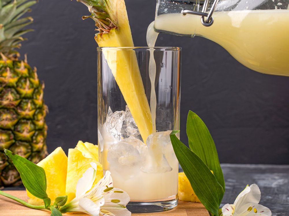 Pouring fresh pineapple juice